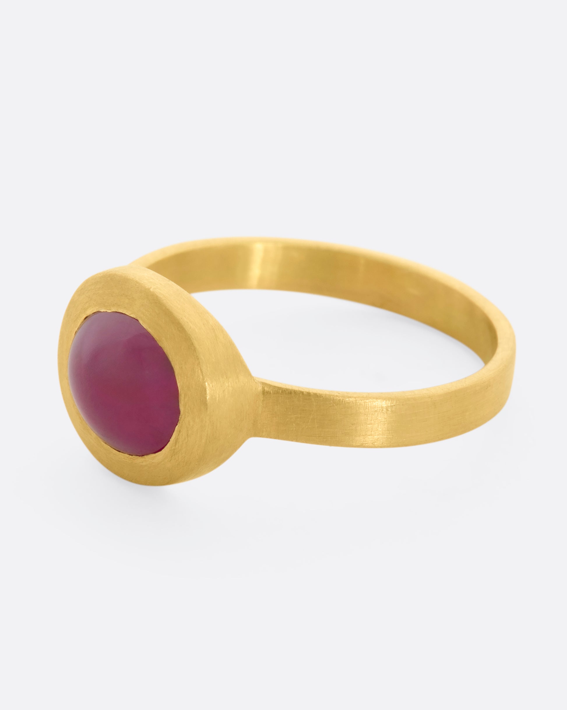 A yellow gold ring with a ruby cabochon. View from the alternate side.