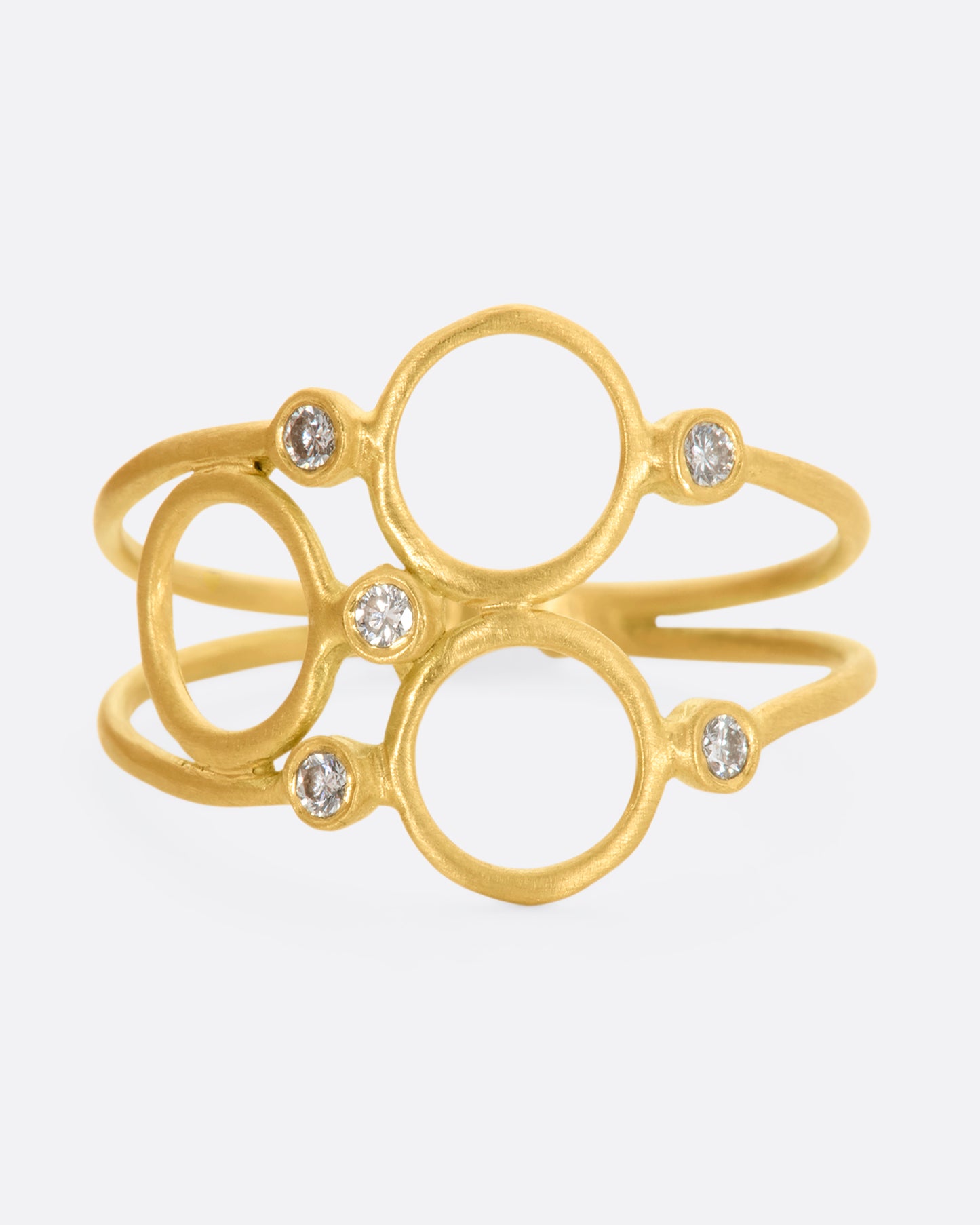 A yellow gold ring with three circles and five diamonds sandwiched between two thin bands. View from the front.