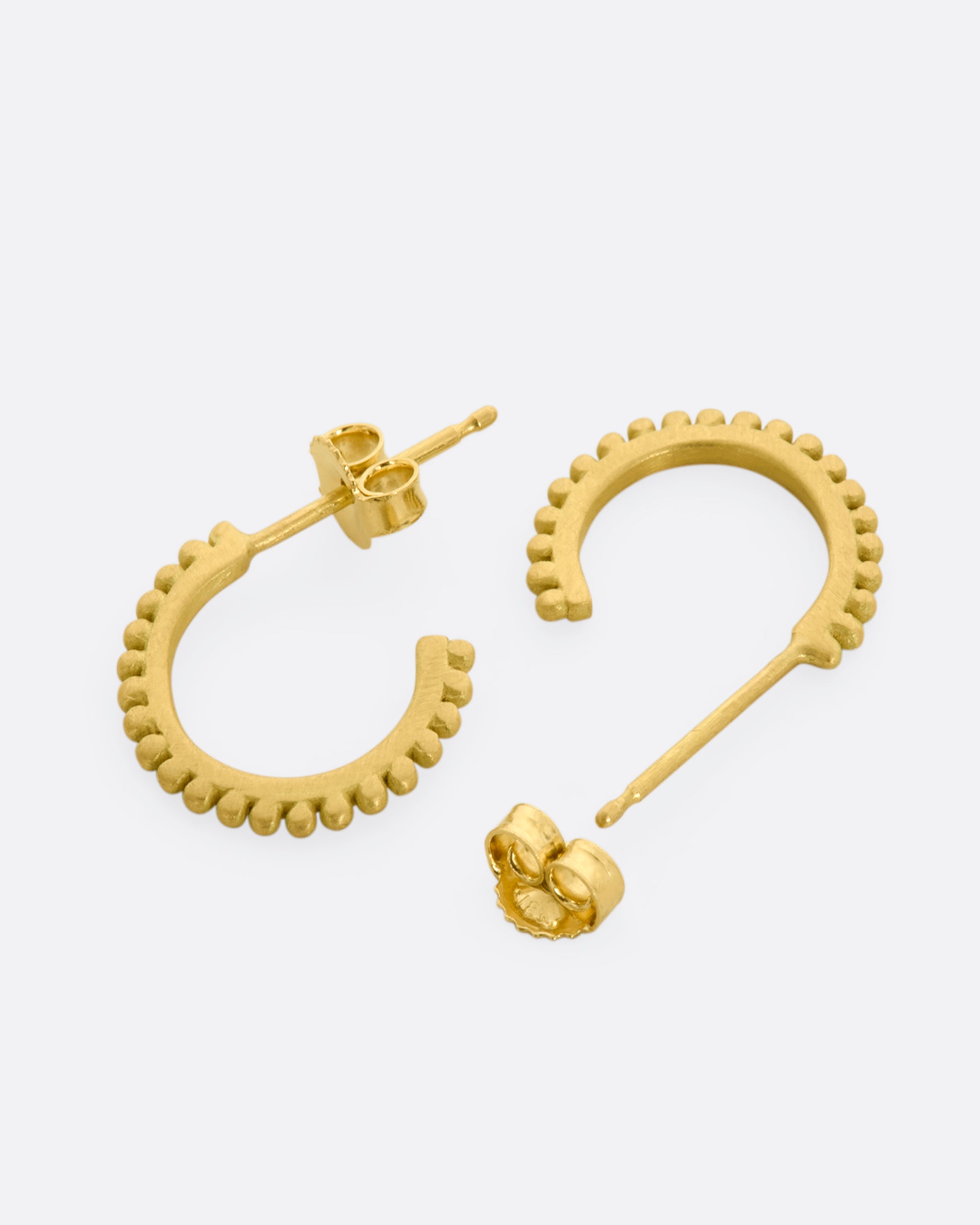 Yellow gold hoops with dotted detail around the edges. View laying flat, alternating.