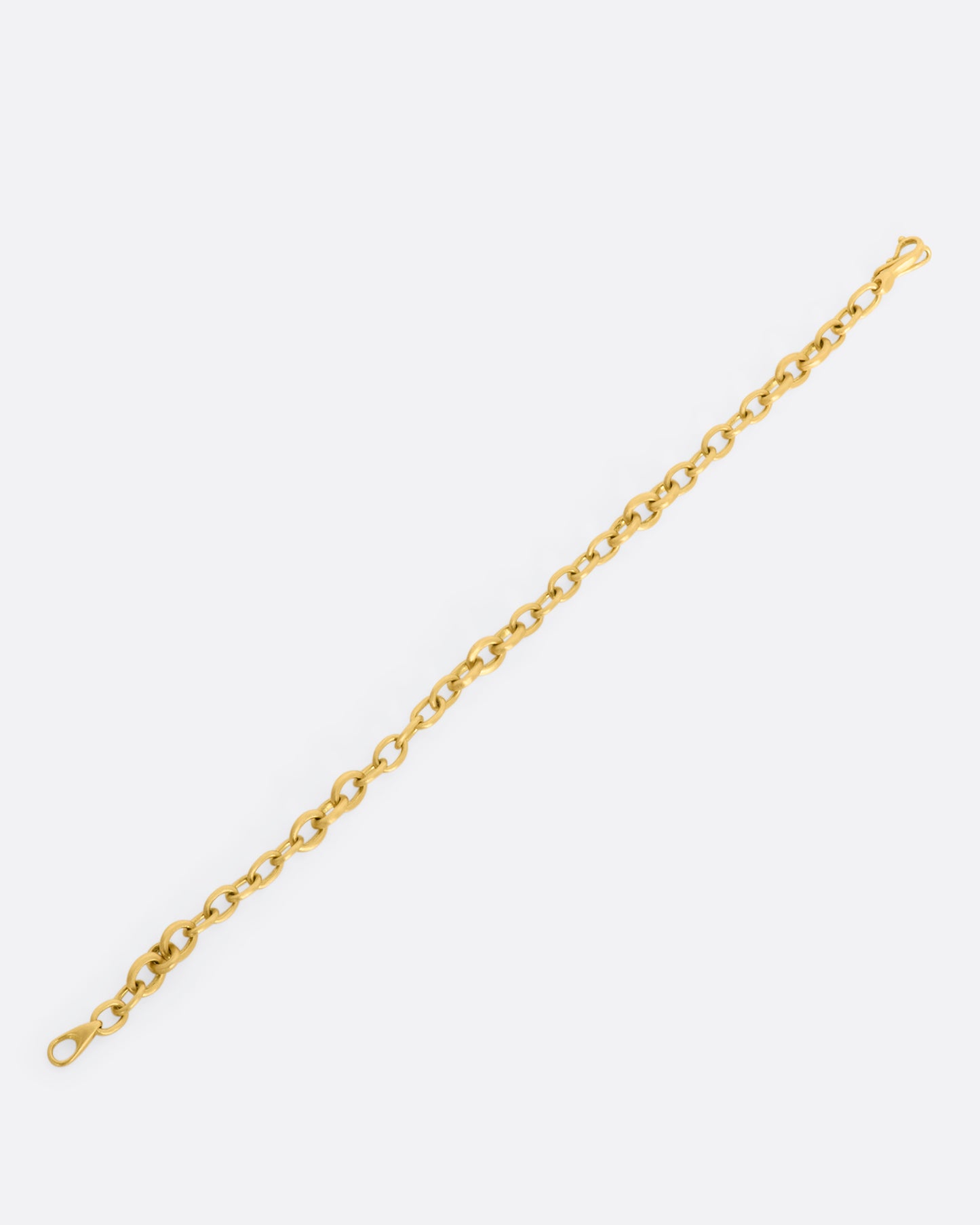 A yellow gold circle link bracelet. Shown laying flat.