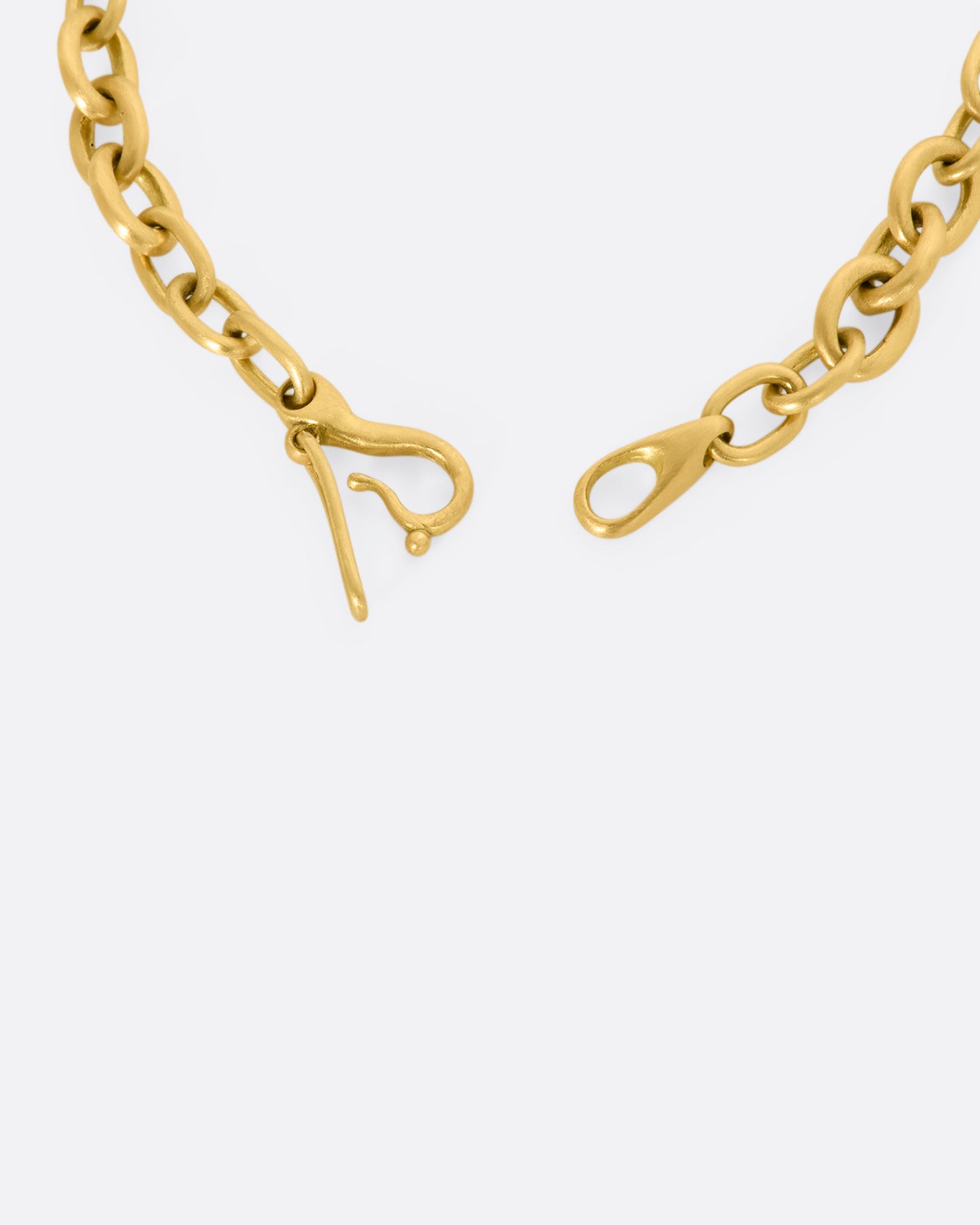 A yellow gold circle link bracelet. Close up of the clasp.