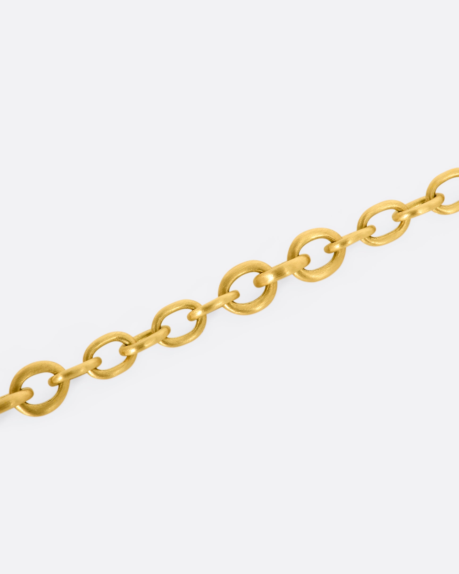 A yellow gold circle link bracelet. Shown close up.