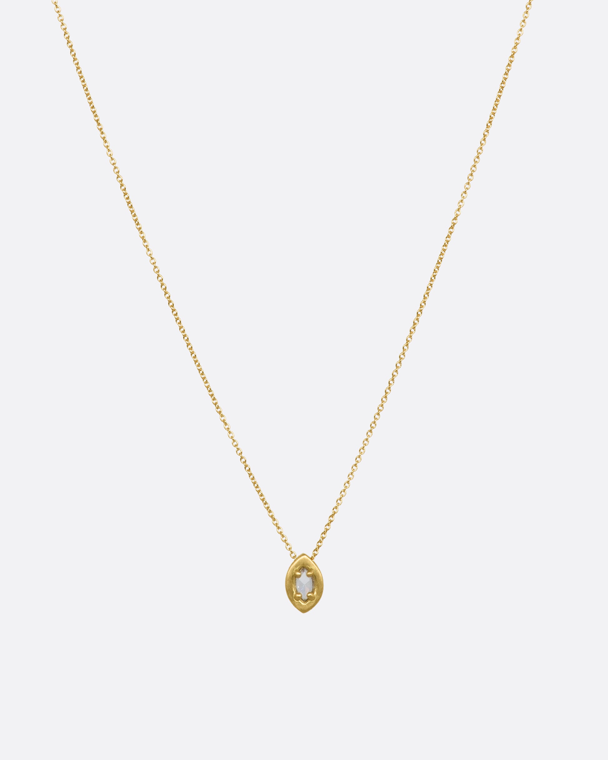 A yellow gold necklace with a prong set marquise diamond pendant. View from the front.