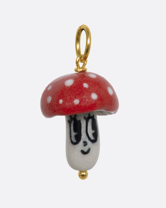 Red mushroom charm on a yellow gold bail. View from the front.