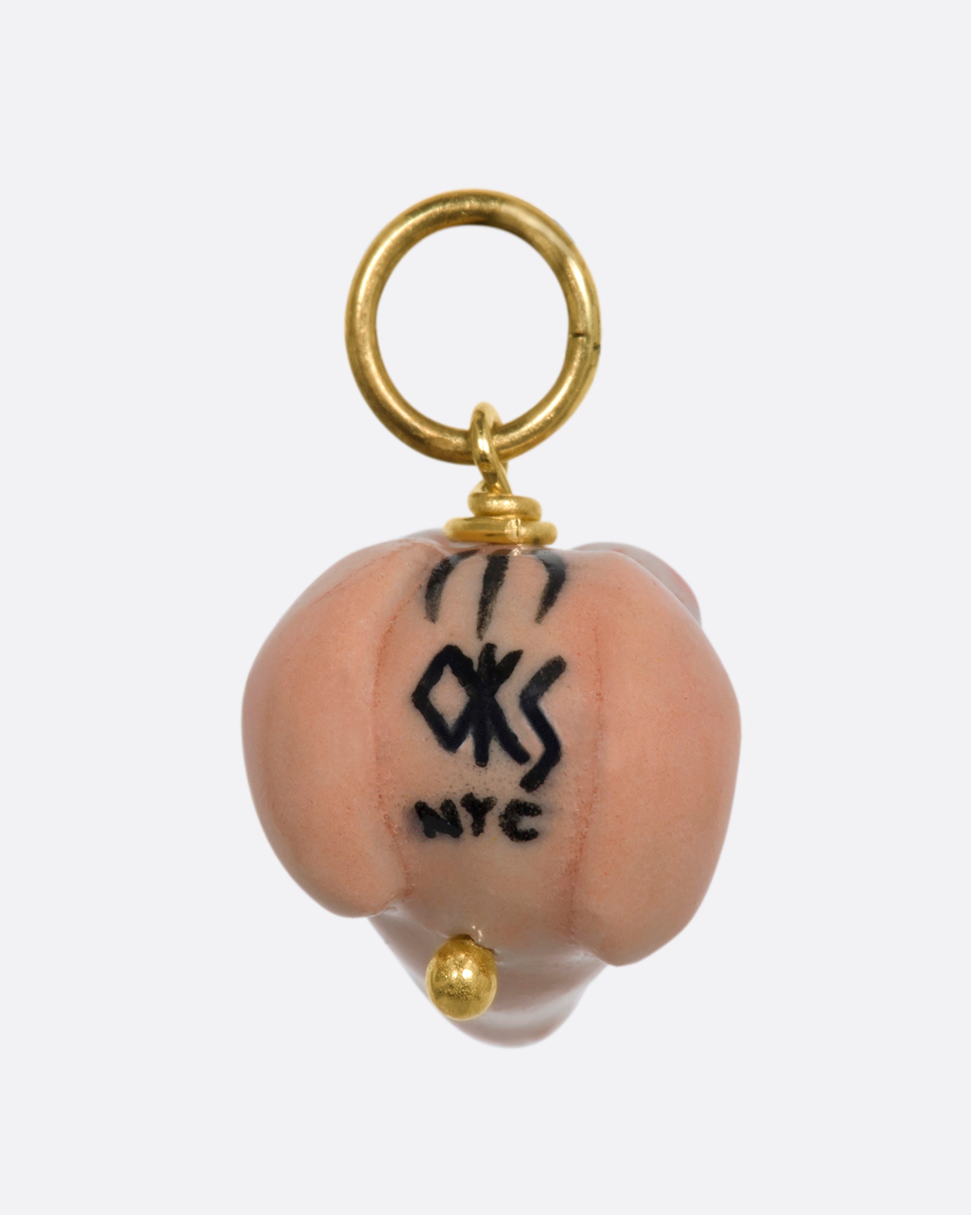 A three dimensional Ren charm with a yellow gold bail. View from the back.