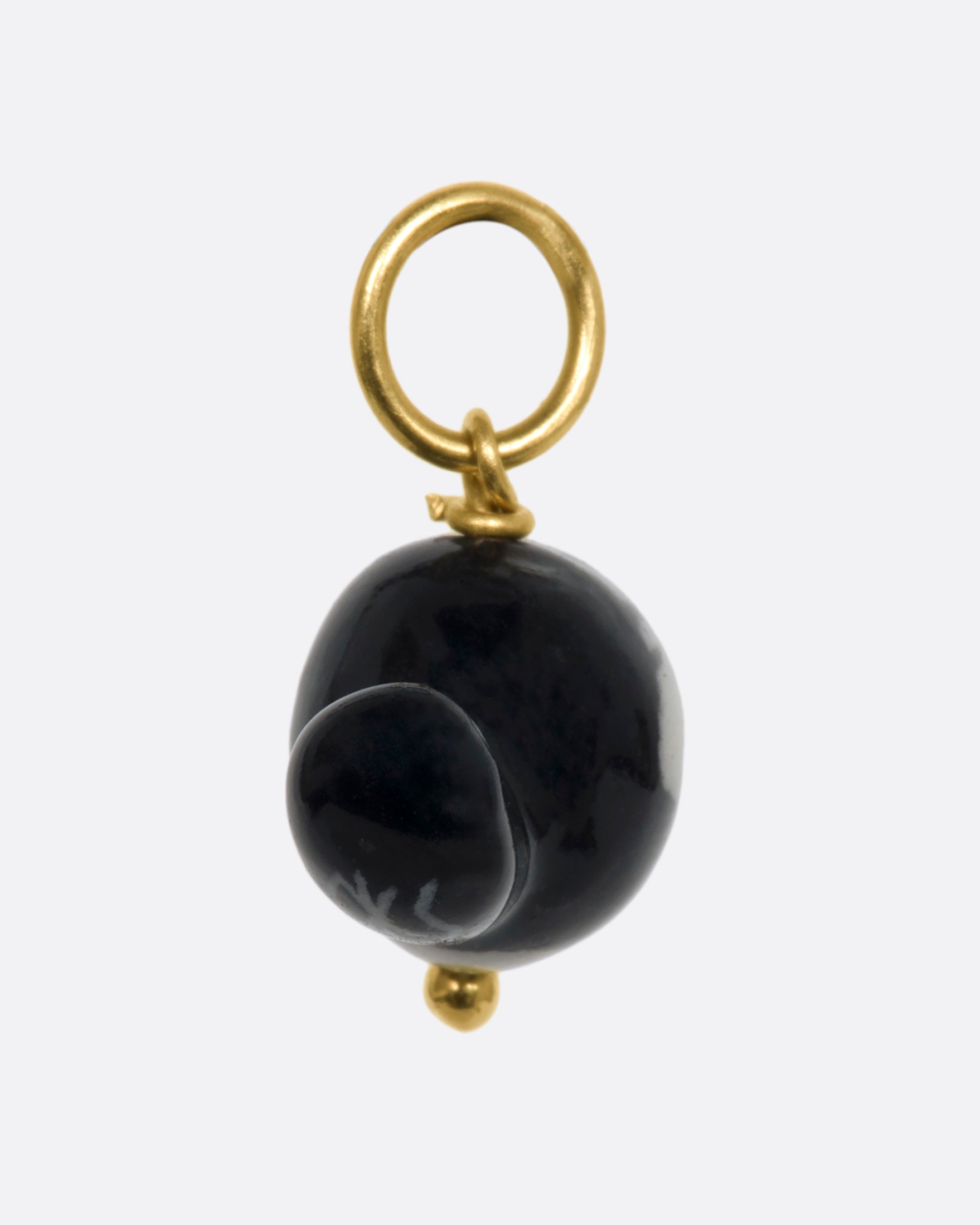 A three dimensional Olive Oyl (from Popeye) charm on a yellow gold bail. View from the back.