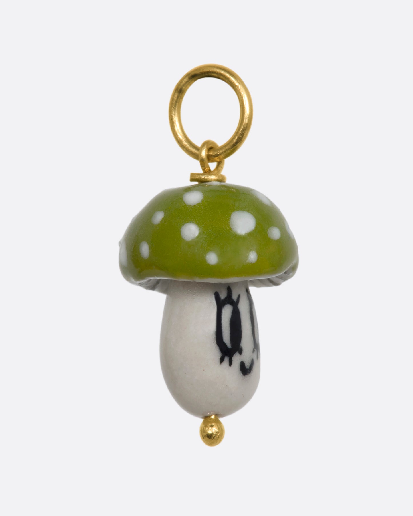 Green mushroom charm on a yellow gold bail. View from the side.