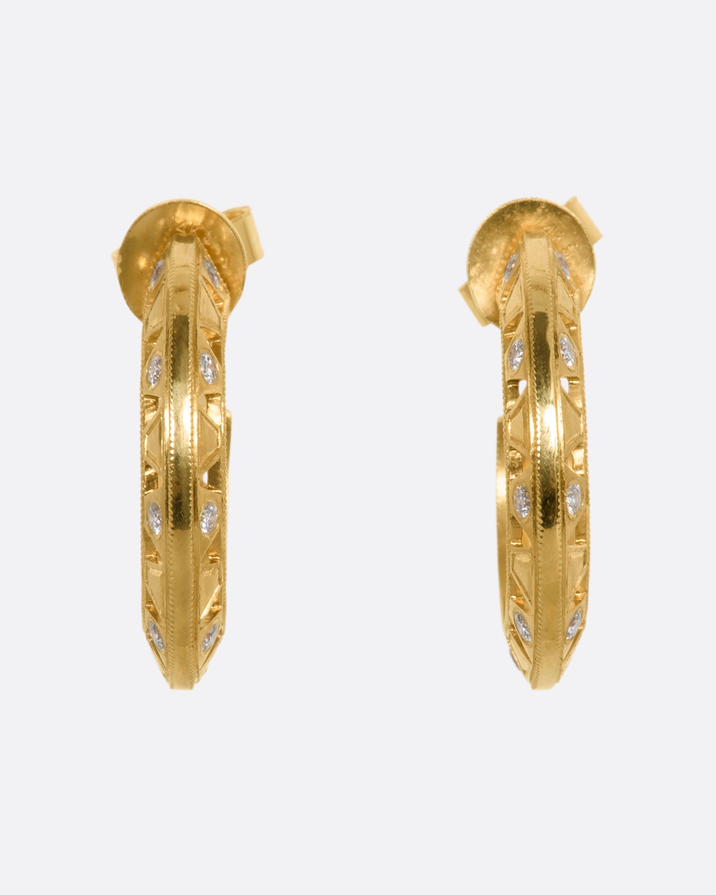 Intricate yellow gold hoop earrings with diamonds. View from the front.