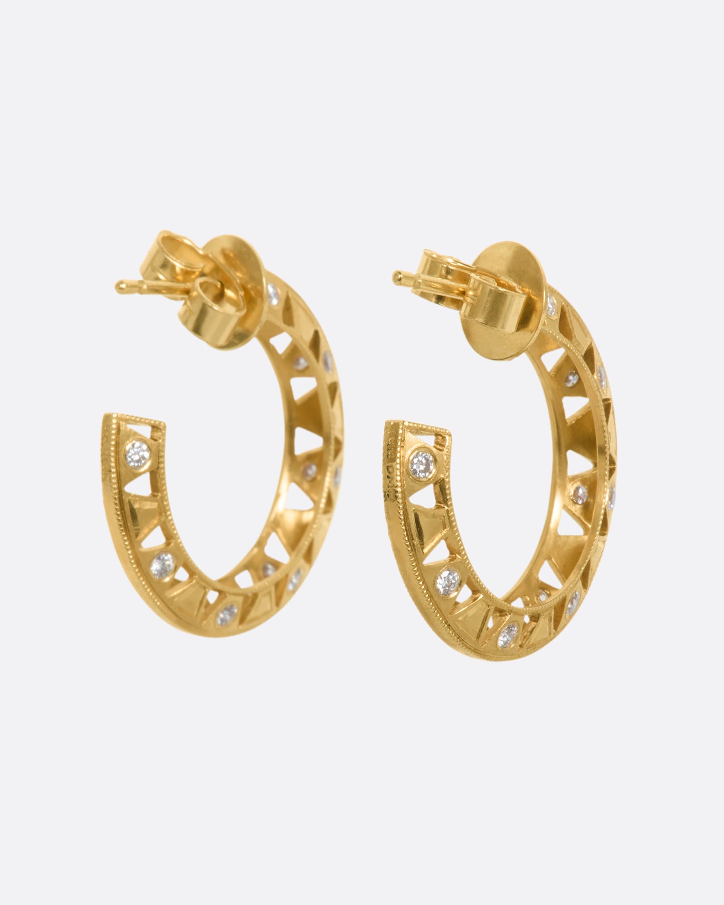 Intricate yellow gold hoop earrings with diamonds. View from the back.