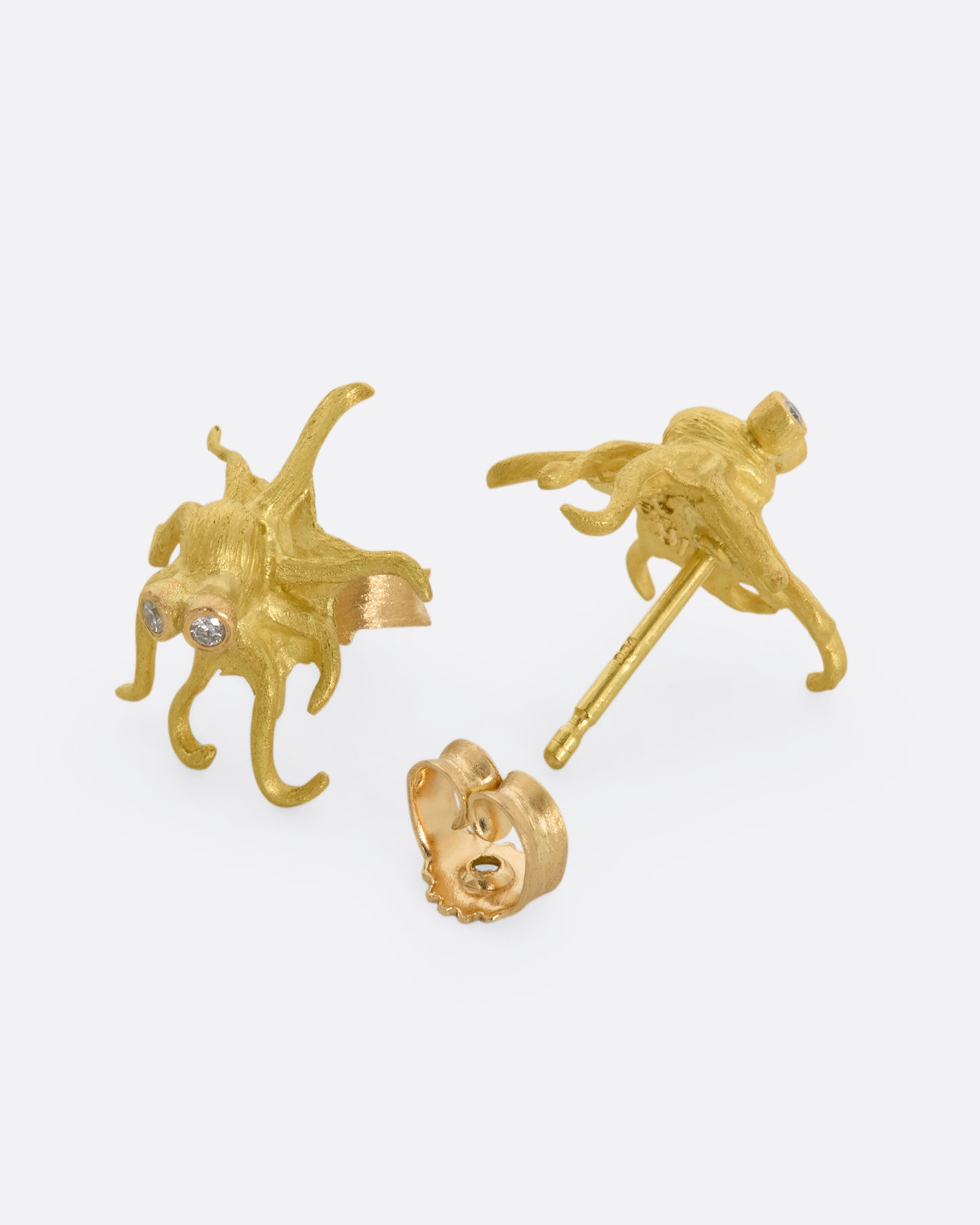 Yellow gold octopus earrings with diamond eyes. View from the front and back alternating.