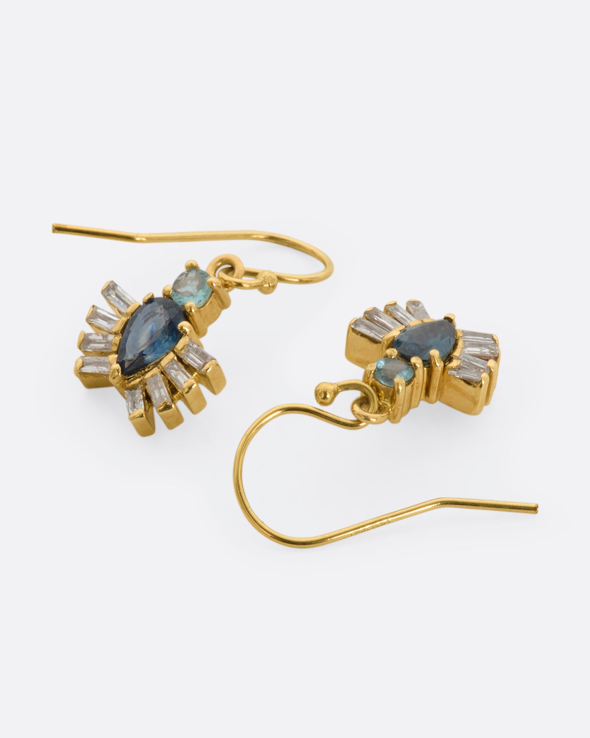 Yellow gold drop earrings with royal beetle dangles made of apatite, sapphires and diamonds. View laying flat.