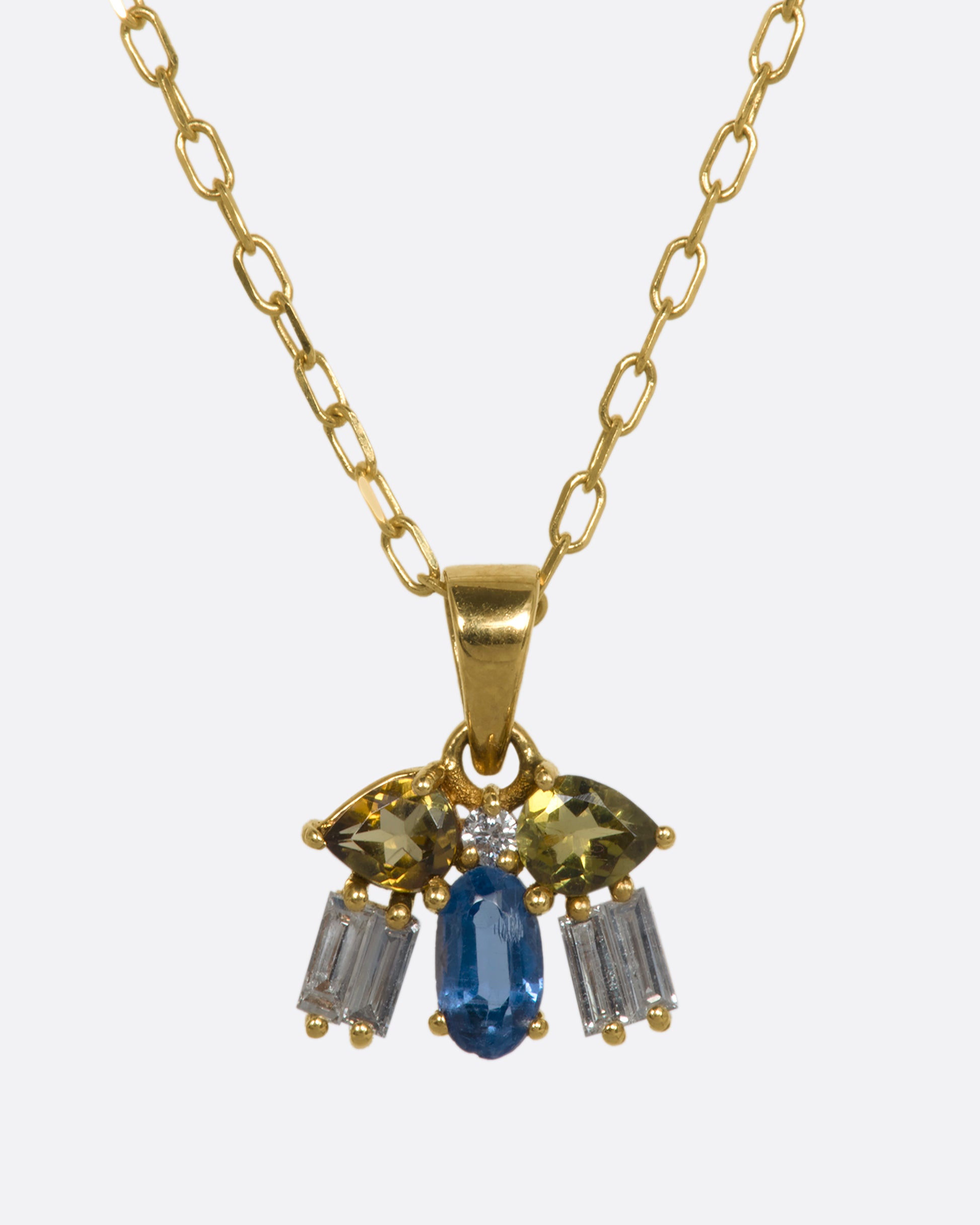 A yellow gold necklace with a winged bug pendant made of tourmalines, kyanite and diamonds. View from the front.