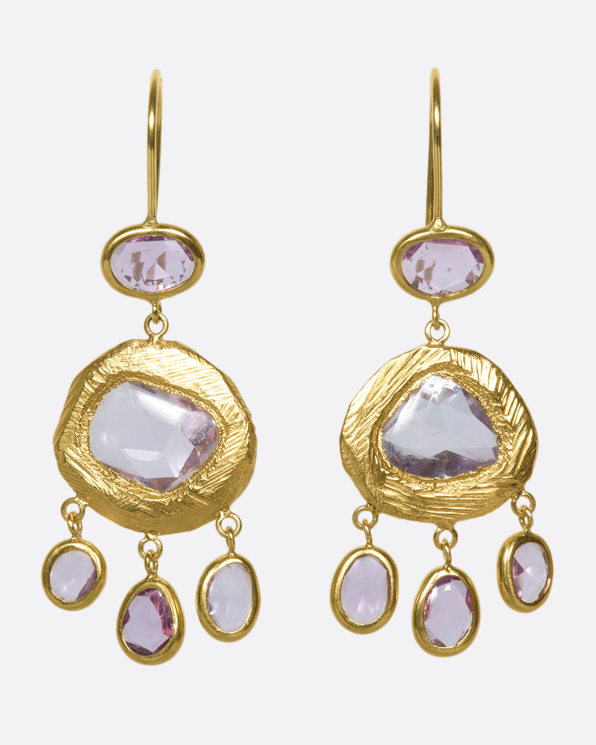 One-of-a-kind three-tiered dangle earrings with pink sapphires set in 18k gold.