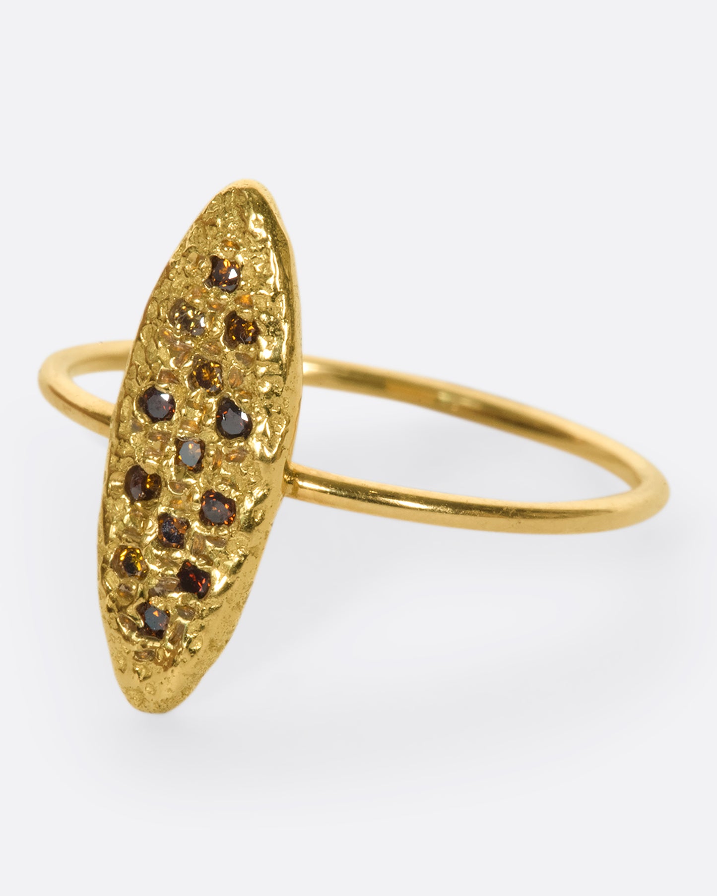 This 18k gold textured oval ring is dotted with vibrant, colorful diamonds