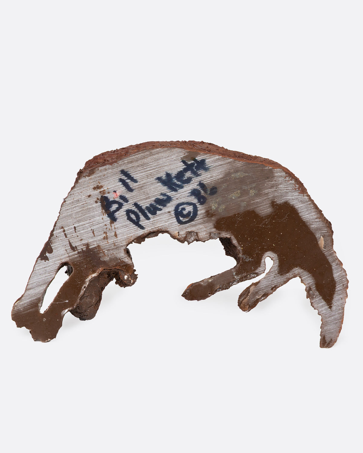 A brown resin dog figurine shown from the bottom.