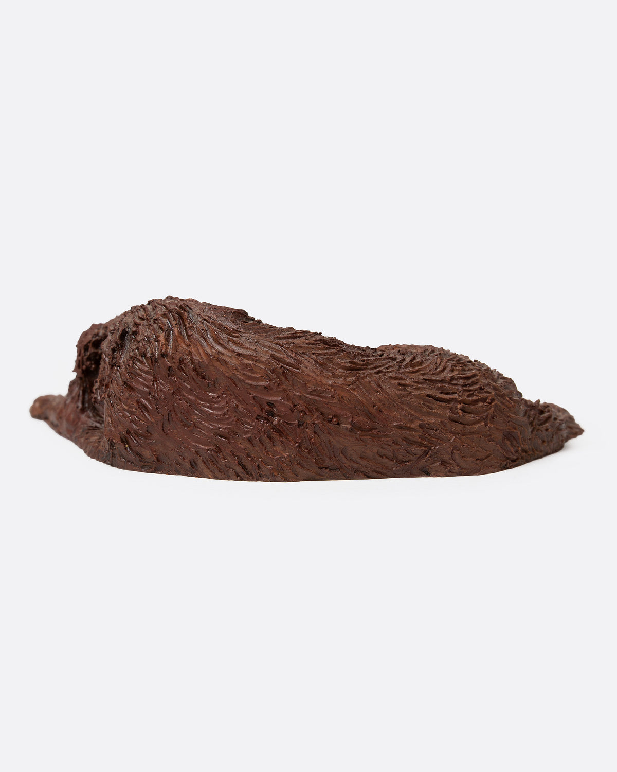 A brown resin dog figurine shown from the back.