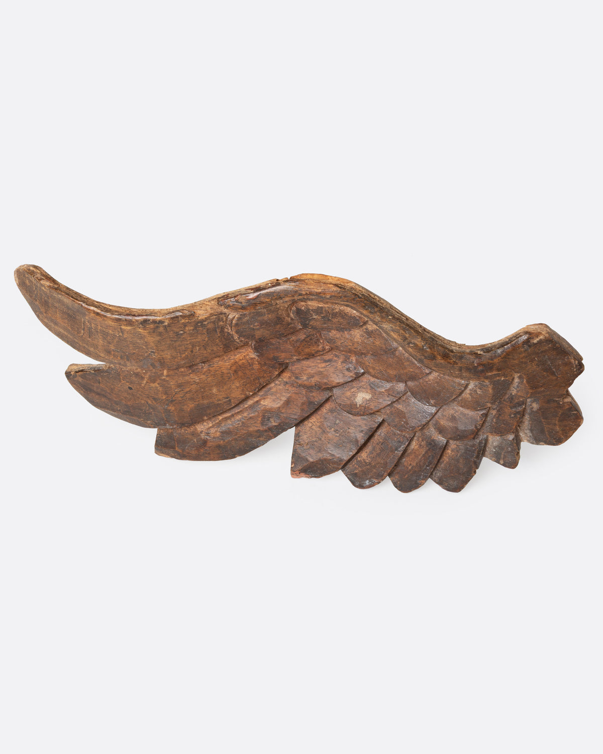A wooden hand carved wing, shown from the front.
