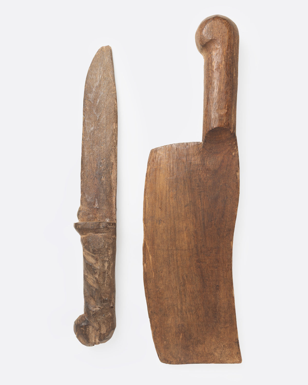 A hand carved wooden knife and cleaver set, shown from the side.