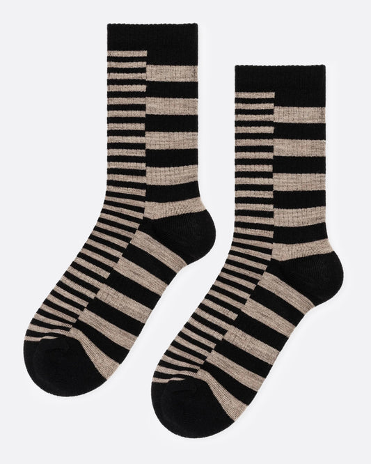 A pair of crew socks with a horizontal striped pattern in black and beige, shown from the side.