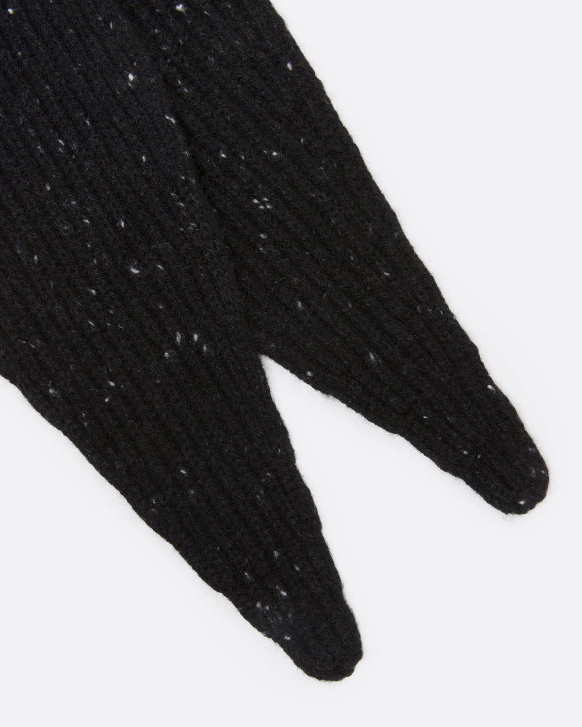 A close up off a black ribbed knit scarf with tiny flecks.