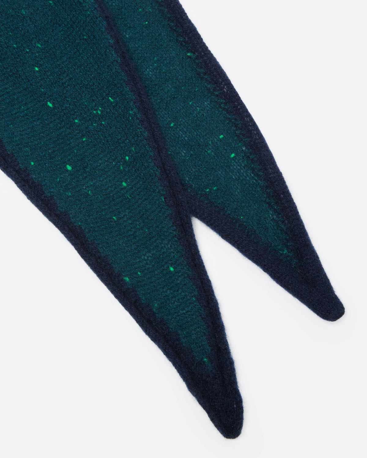 A close up of a dark teal green ribbed knit scarf with tiny bright green fleck, and a navy striped border.