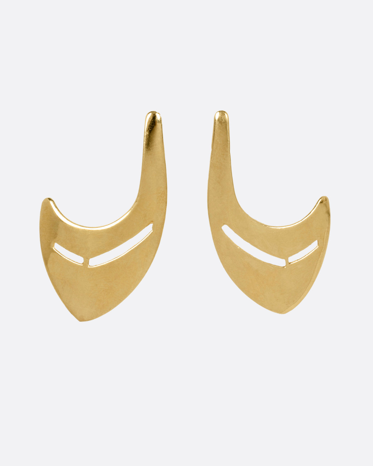 A pair of yellow gold curved earrings with cutouts, shown from the front.