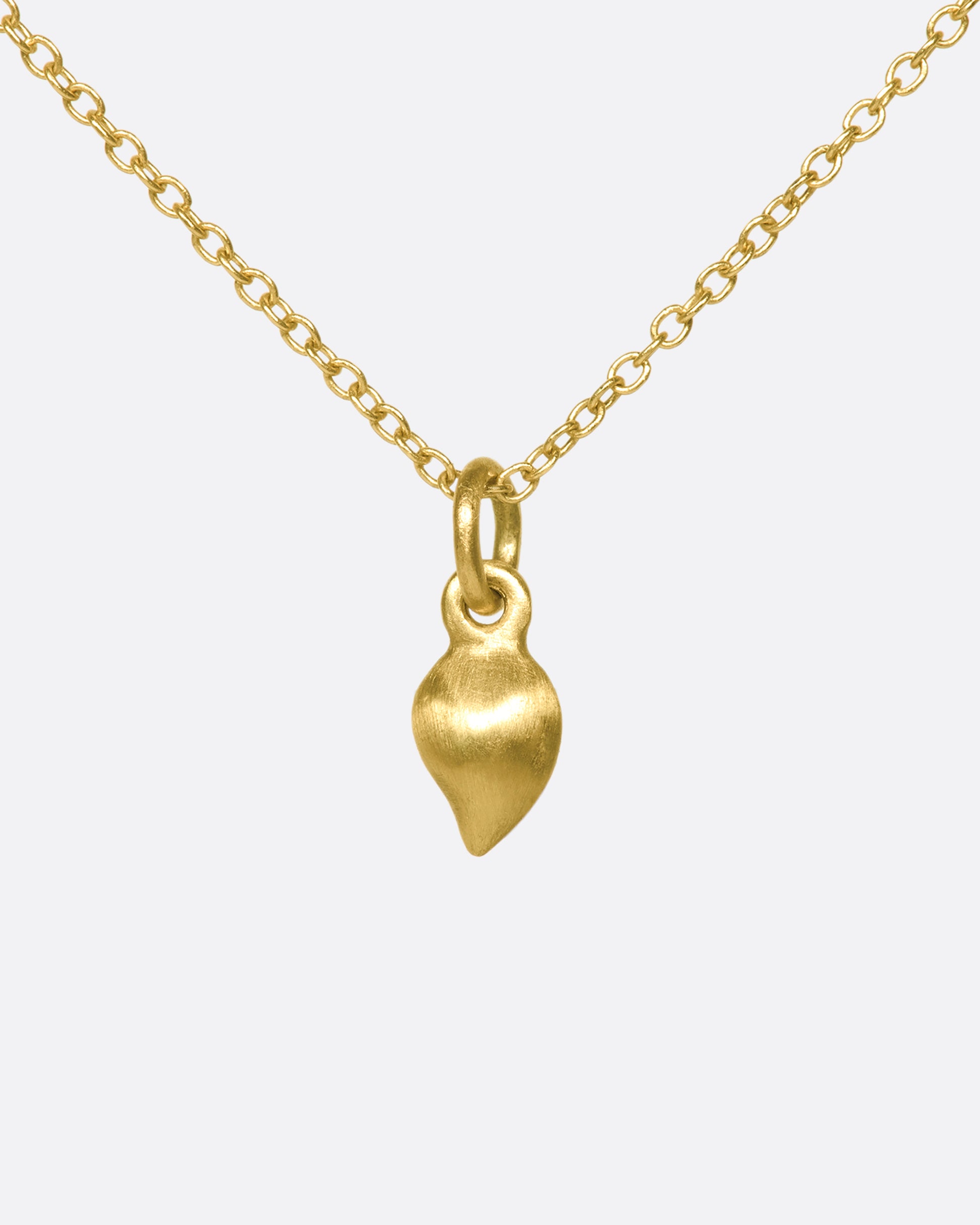 This delicate 10k gold necklace features two diamonds sparkling in a gold droplet