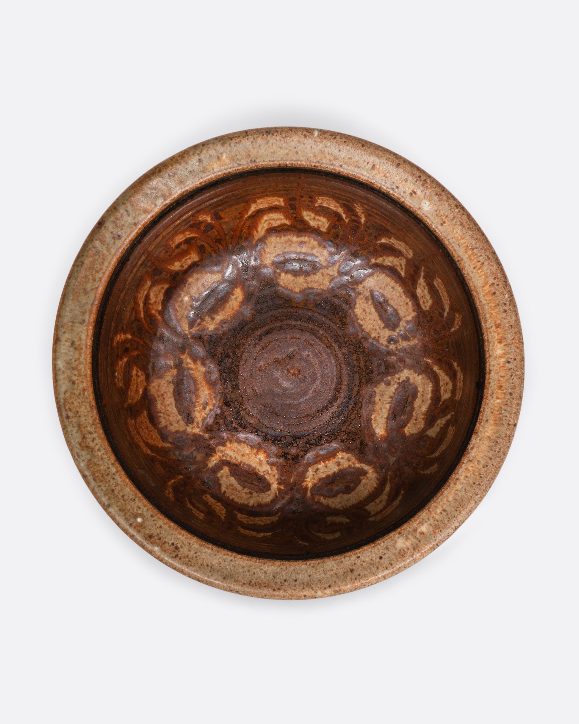 A ceramic lipped bowl with a painted interior. View of the interior.