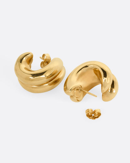 Vintage yellow gold domed huggie earrings, the pair laid flat showing the posts