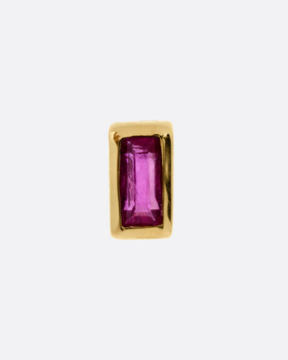 A yellow gold stud earring with a baguette cut ruby, shown from the front.