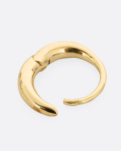 A yellow gold tapered hoop earring with a queue of graduated diamonds, shown from the side open.