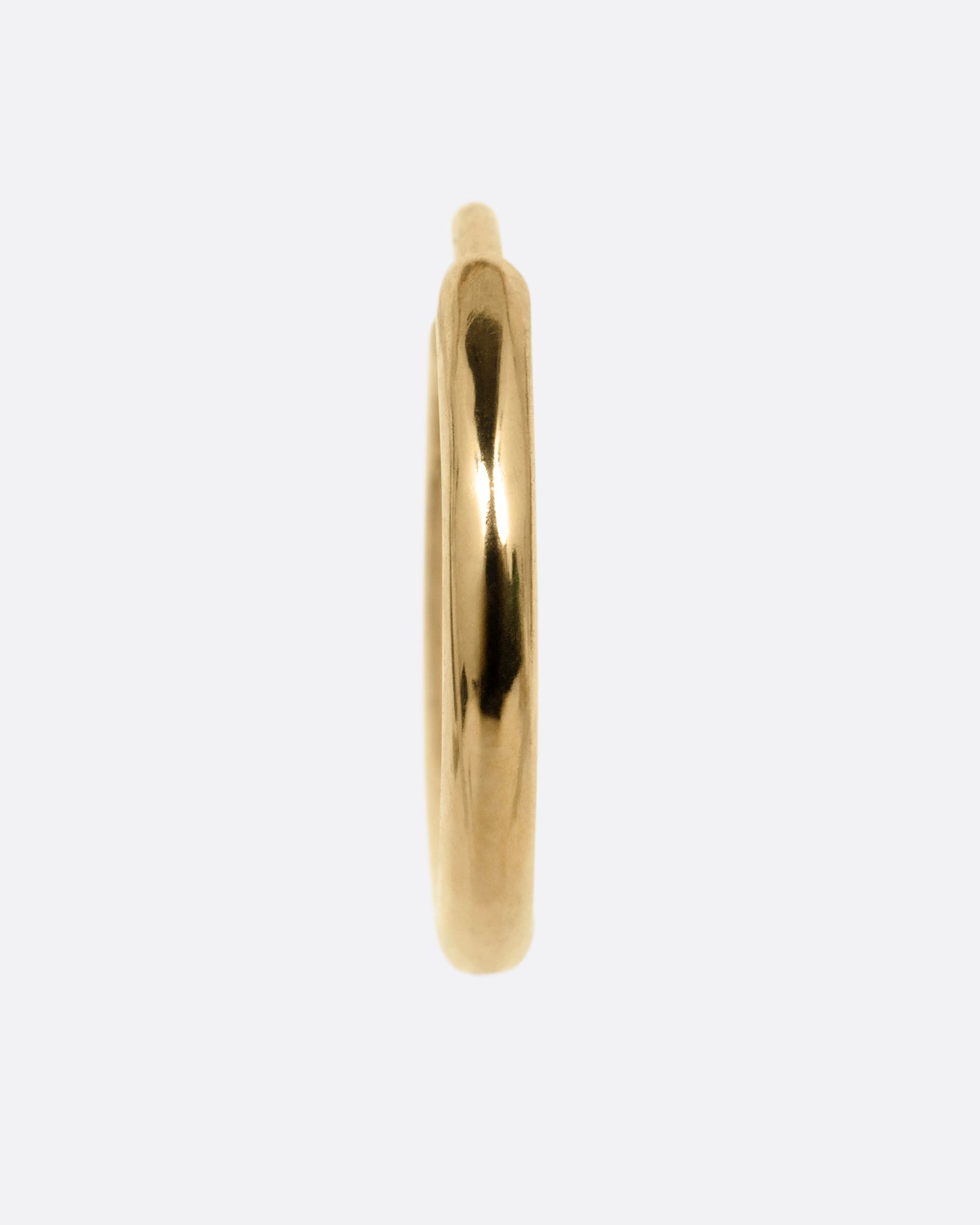 A yellow gold hoop earring with a hinged clicker clasp, shown from the front.