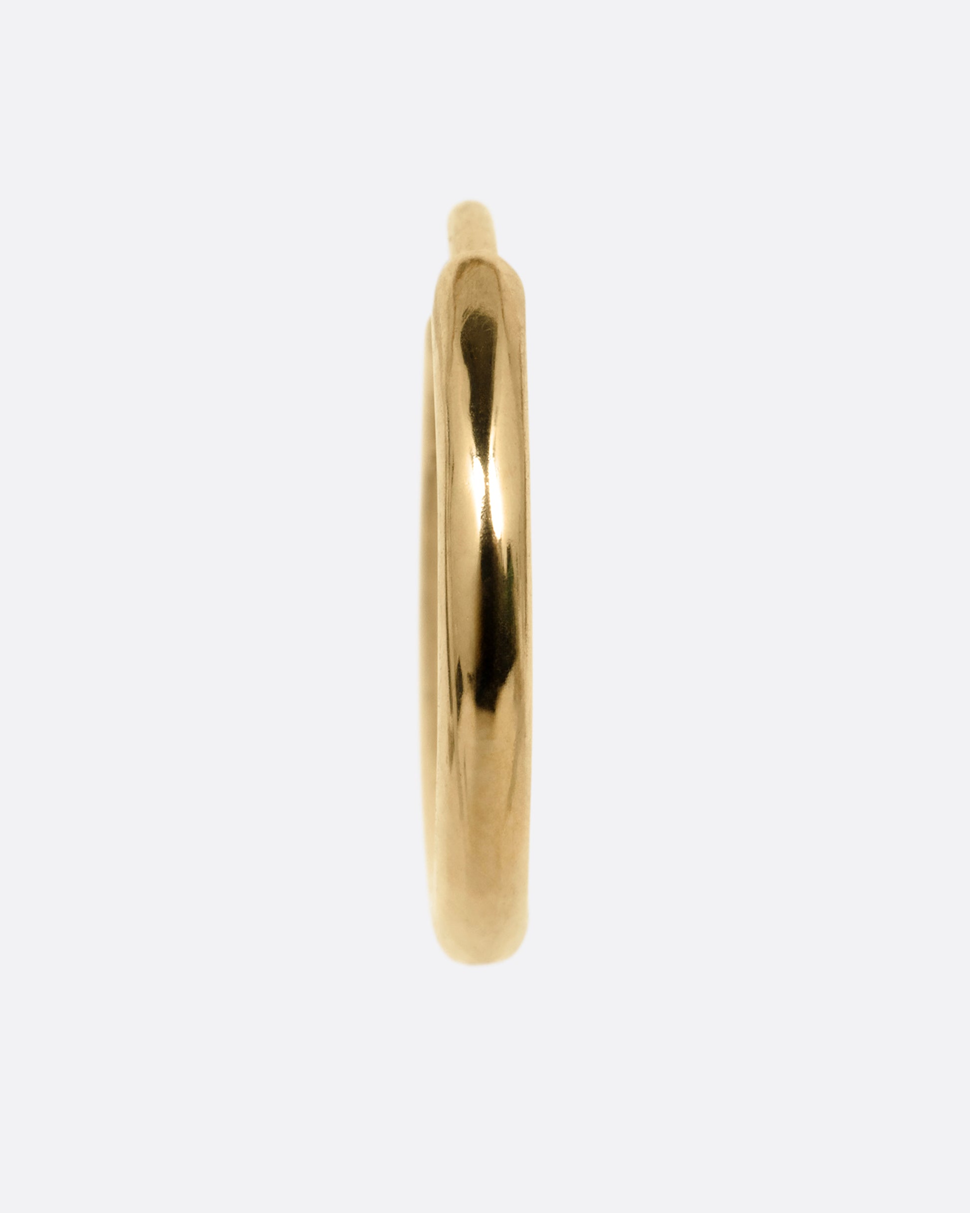 A yellow gold hoop earring with a hinged clicker clasp, shown from the front.