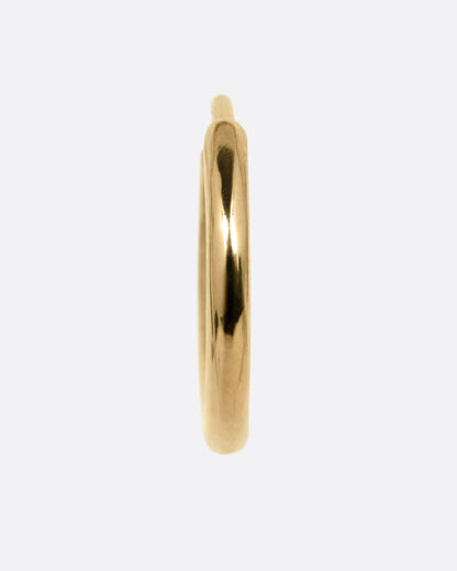 A yellow gold hoop earring with a hinged clicker clasp, shown from the front.