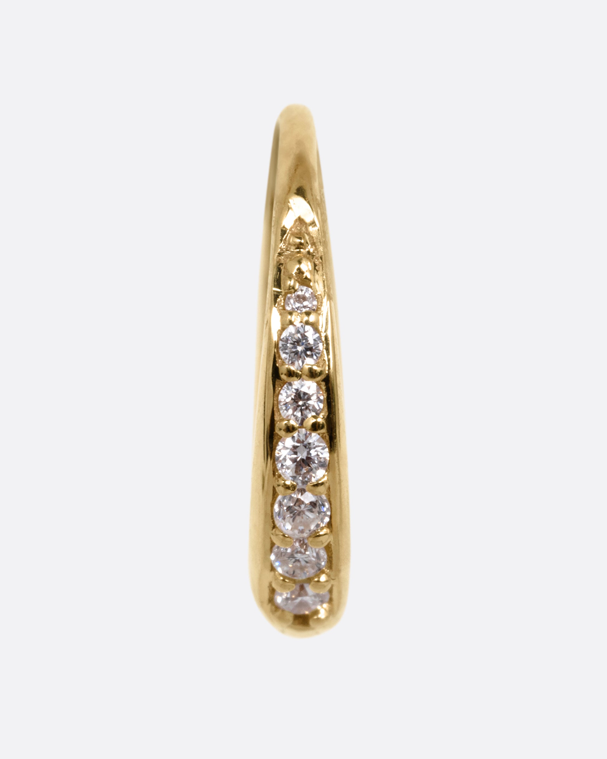 A yellow gold tapered hoop earring with a queue of graduated diamonds, shown from the front.