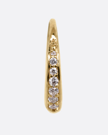 A yellow gold tapered hoop earring with a queue of graduated diamonds, shown from the front.