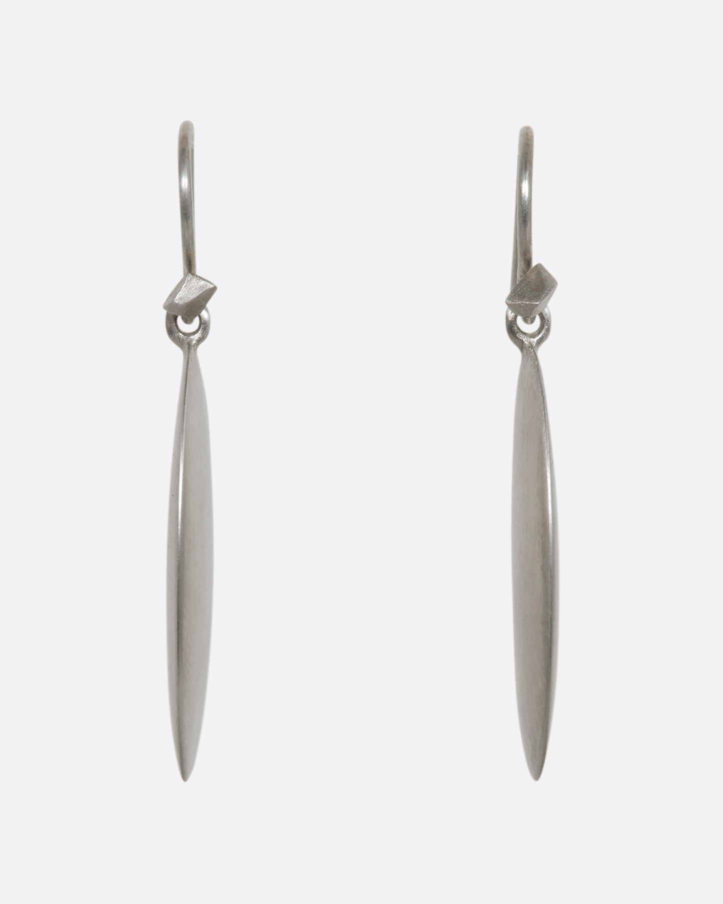 Sterling silver long flat oval dangle earrings. View from the front.