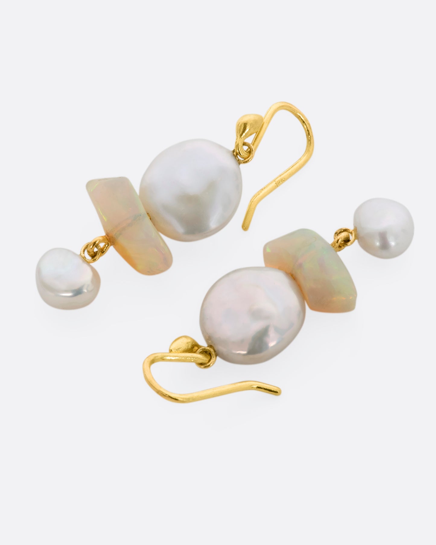 Yellow gold triple tier drop earrings with pearls and opals. View laying flat.