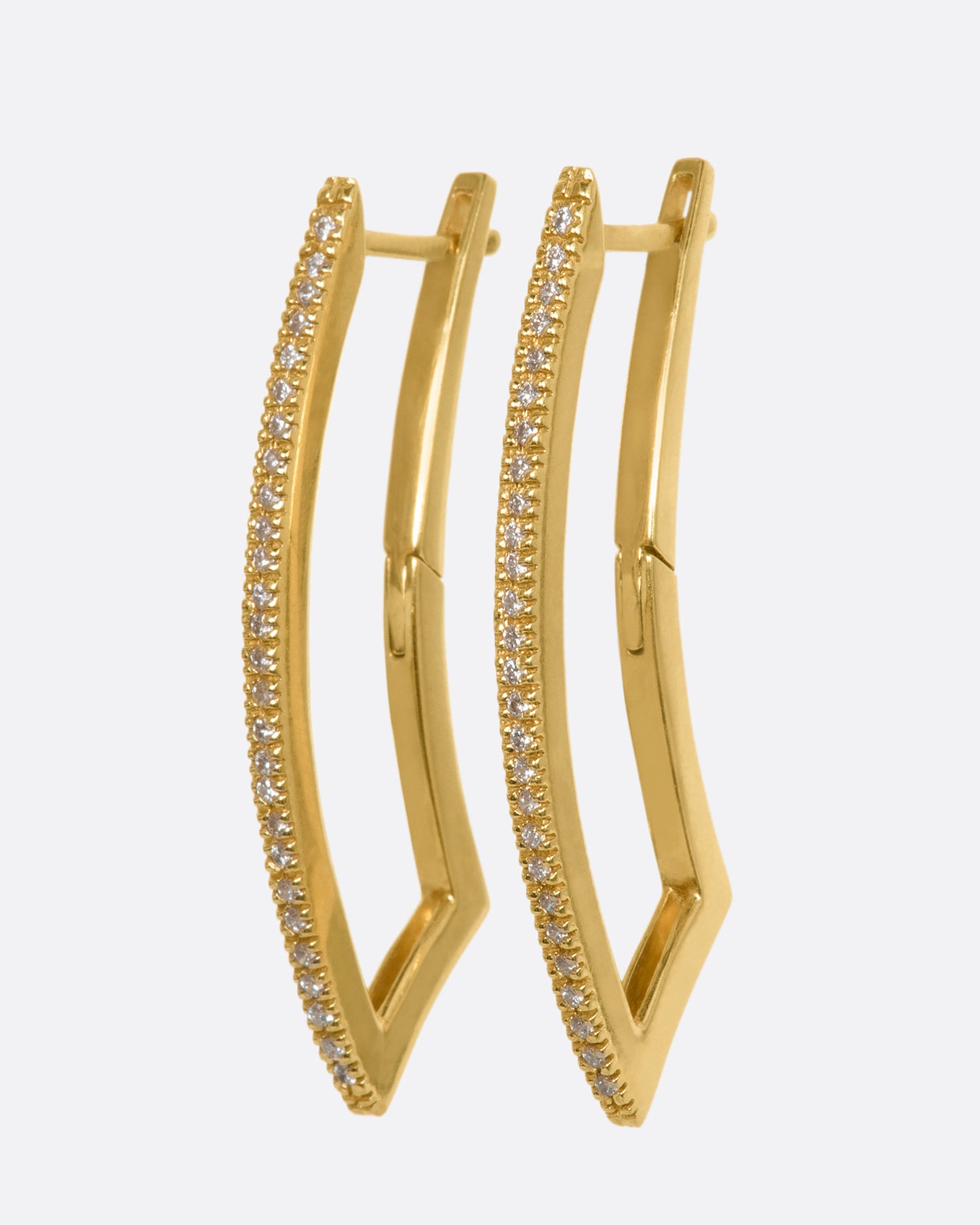 A pair of curved rectangle hoop earrings with pave diamonds. View from the side.