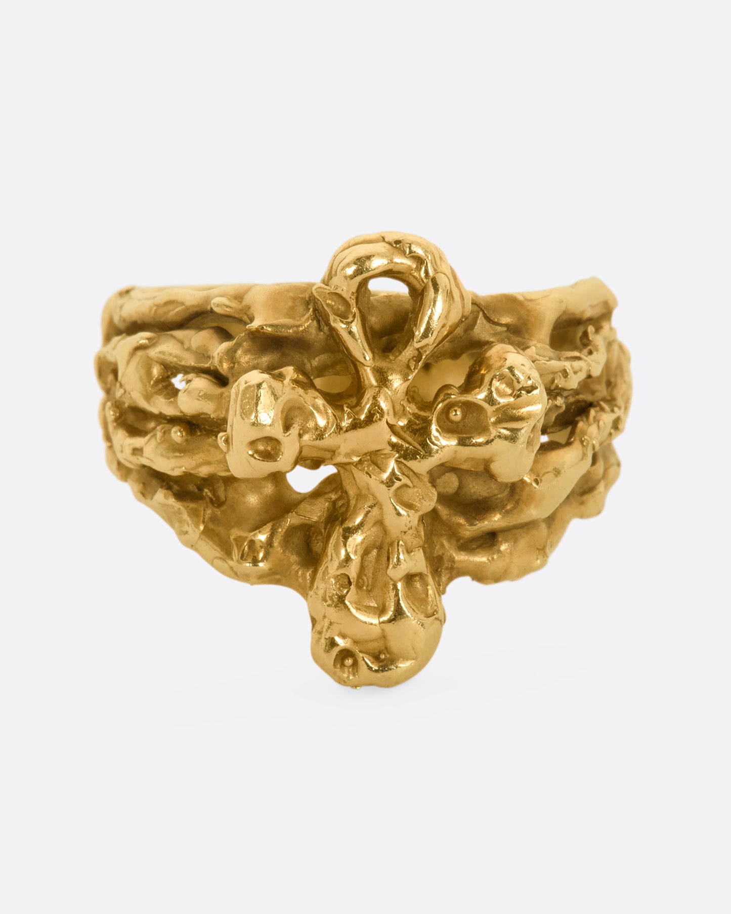 A yellow gold nugget ring with and ankh symbol. View from the front.