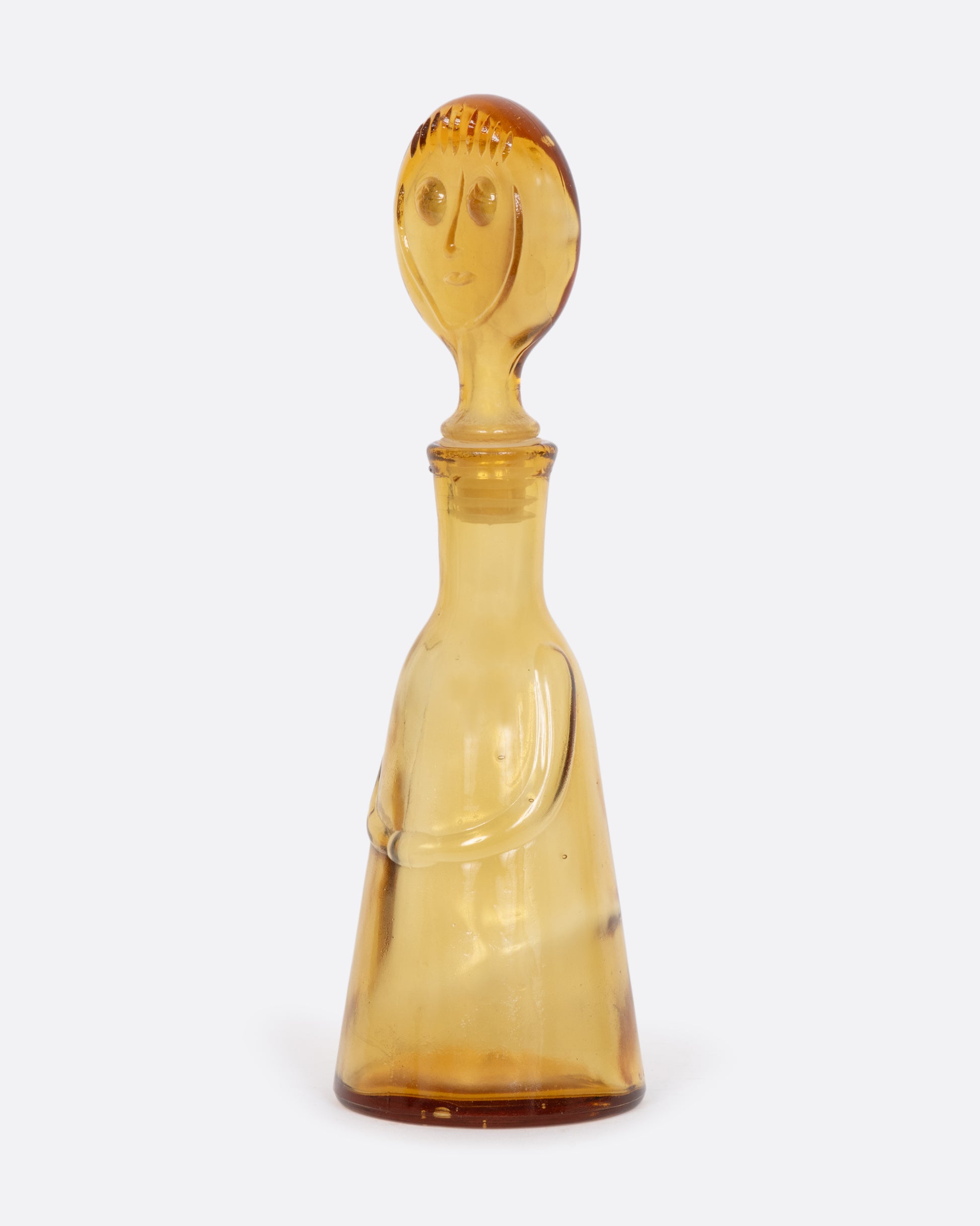 Clear yellow glass person decanter. View from the side.