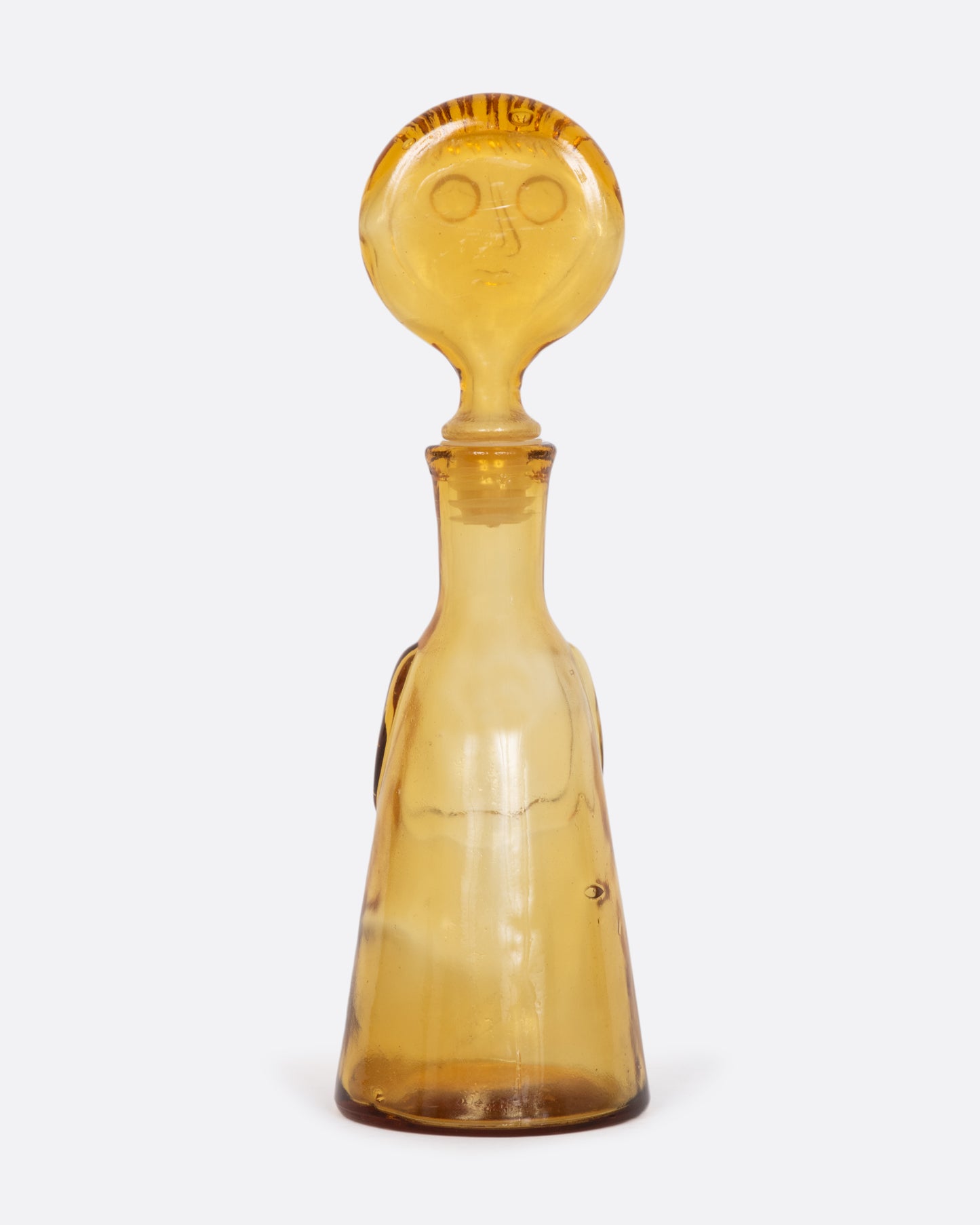 Clear yellow glass person decanter. View from the back.