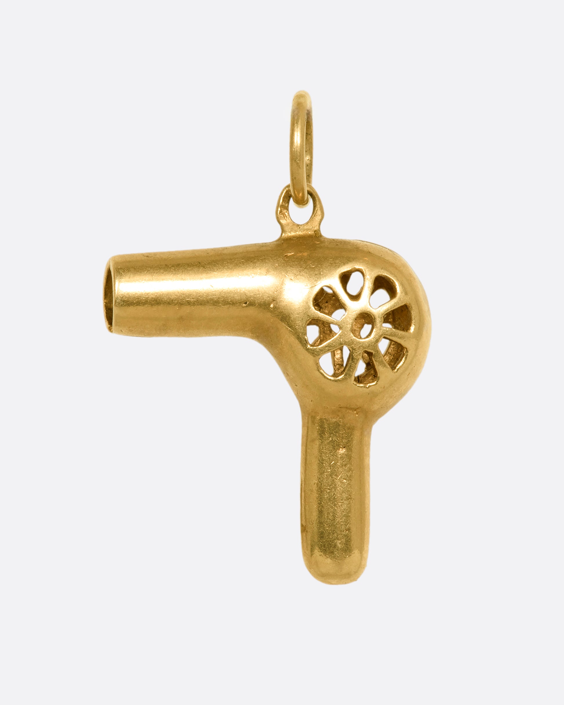 A three dimensional yellow gold hair dryer charm or pendant. View from the front.