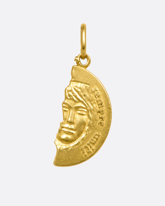 A yellow gold pendant with half a face. View from the front. 