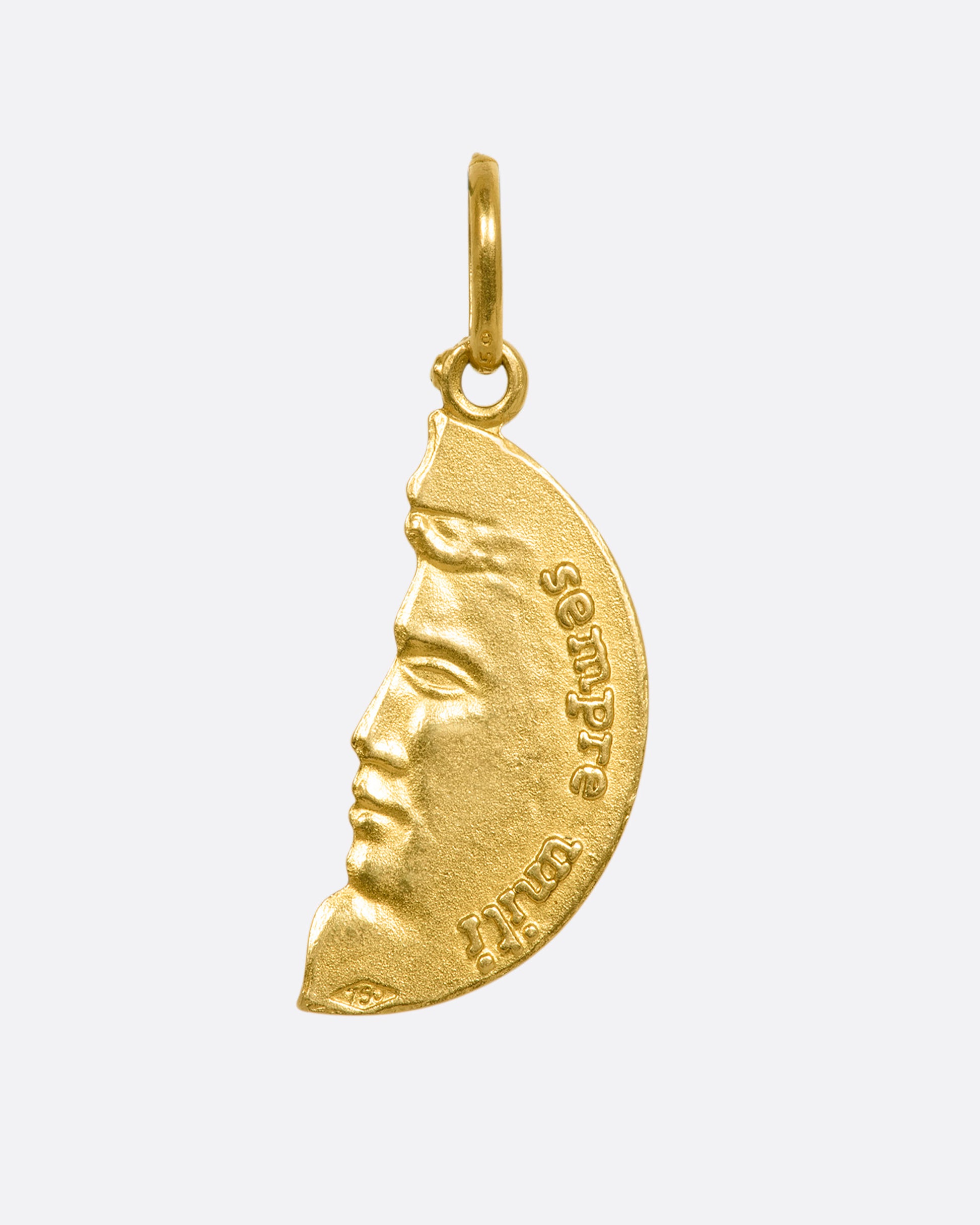 A yellow gold half circle pendant with a face profile. View from the back.