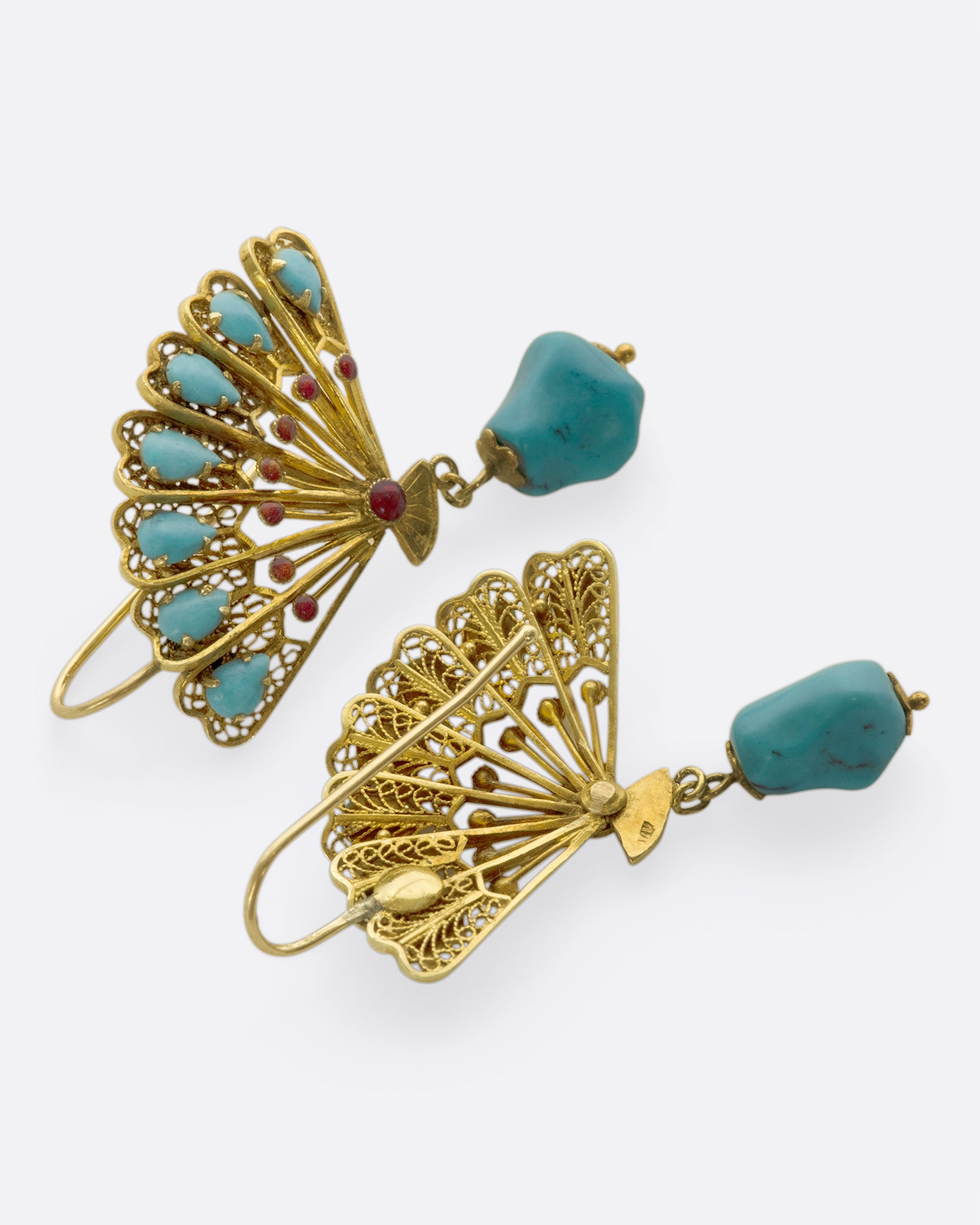 A pair of beautiful gold fan earrings with turquoises and red enamel details. We love these for their vintage vibe, versatile color palette, and sense of balance the hanging stones creates.