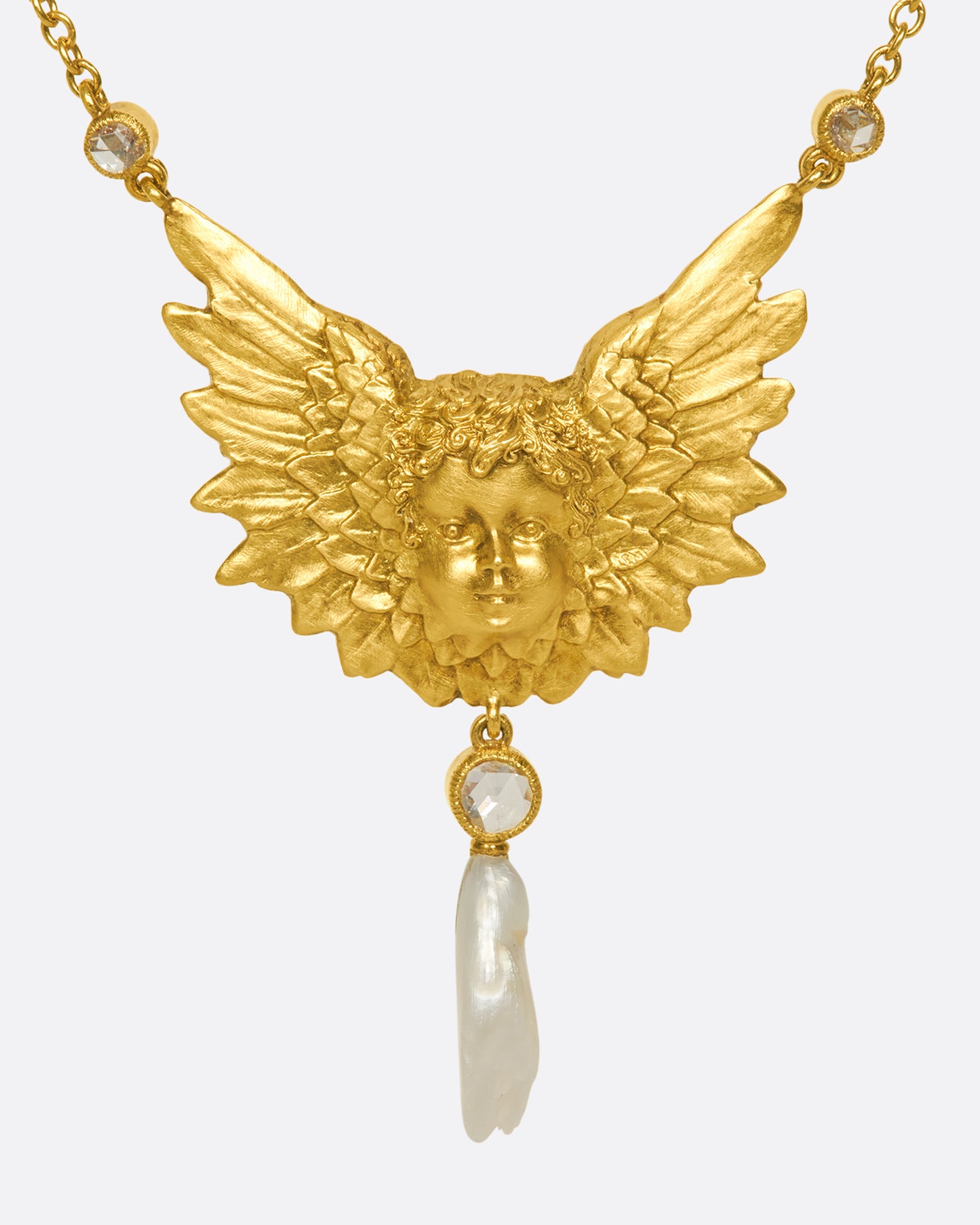 A show-stopping 18k gold cherub necklace with three bezel-set rose-cut white diamonds and a natural pearl drop