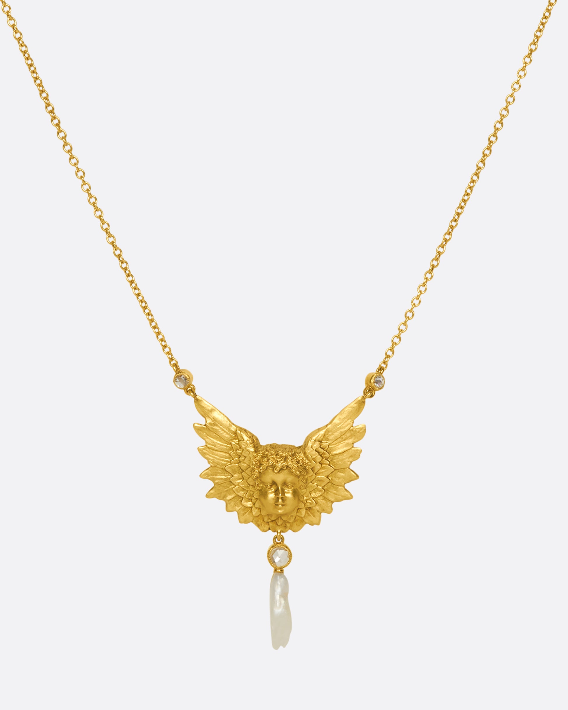 A show-stopping 18k gold cherub necklace with three bezel-set rose-cut white diamonds and a natural pearl drop