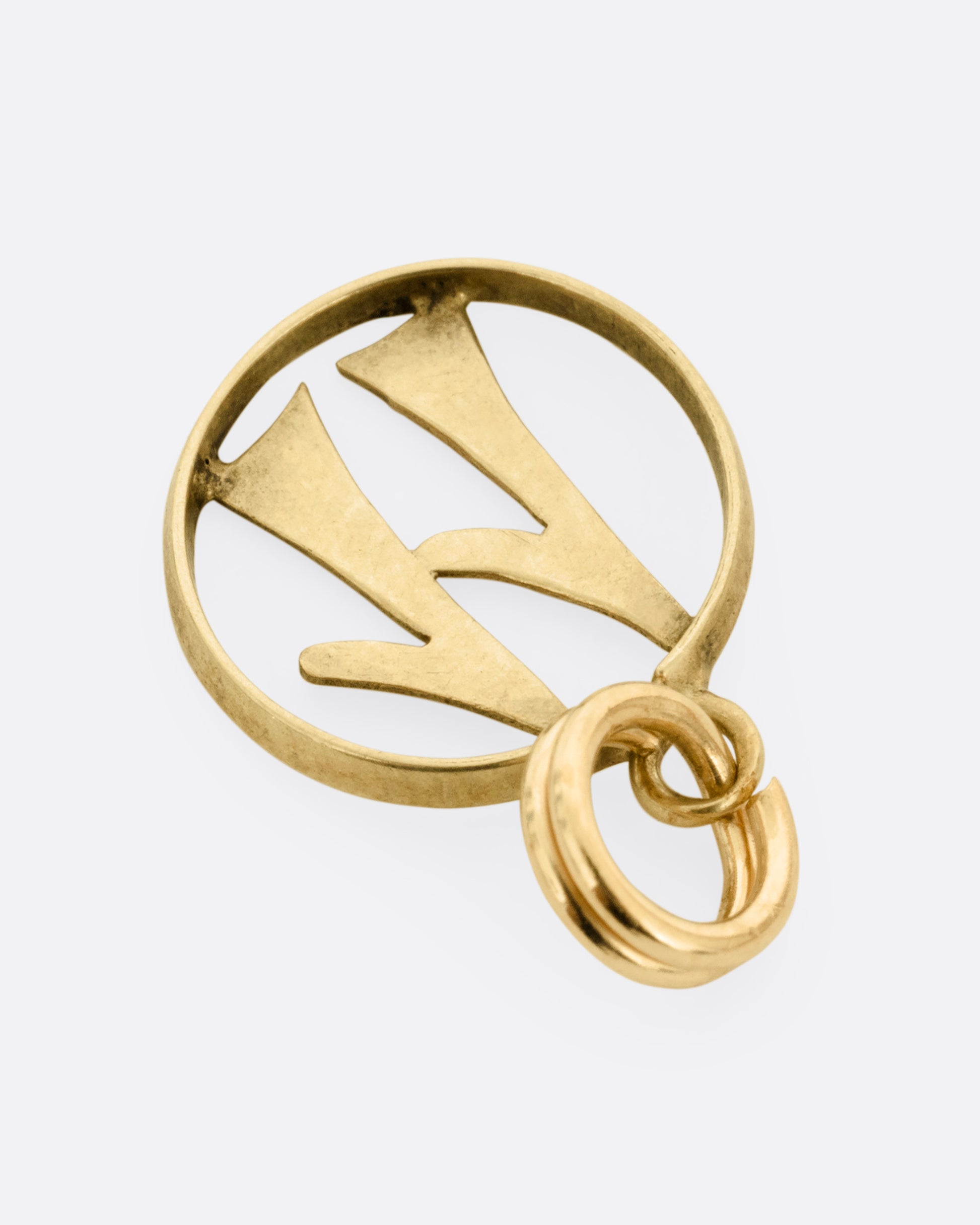 An open round yellow gold '11' pendant, shown from the back.