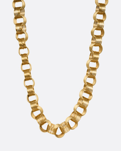 A yellow gold necklace with slanted stacked hoop links, shown from the front.